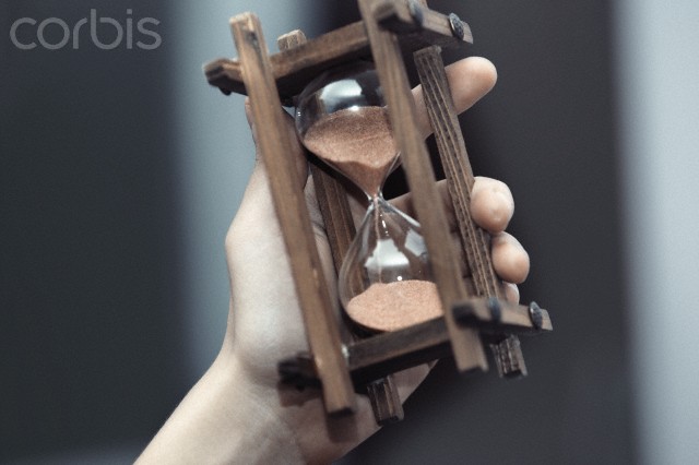 Hand holding hourglass